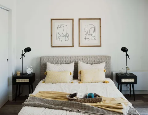 Bedroom with a double bed, bedside tables and lamps.