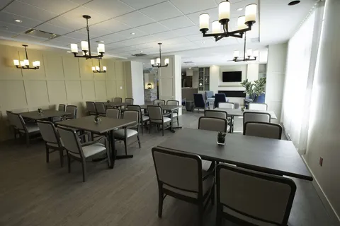 Dining room with rows of tables and chairs.