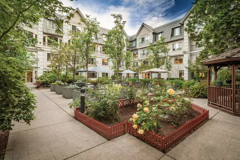 Residence beside a courtyard with planted beds and paths