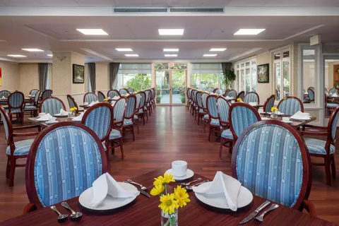 Dining room with set tables, chairs and large windows