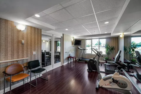 Fitness room with exercise machines and mirrors