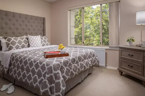 Bedroom with a bed, dresser and window