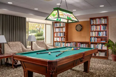 Room with a pool table and seating
