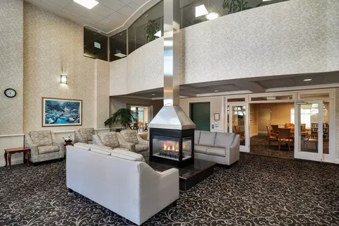 Room with sofas and armchairs around a fireplace