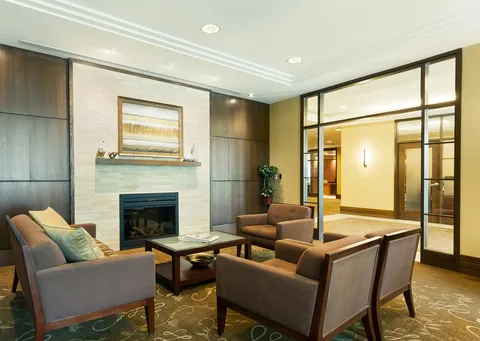 Fireside lounge with armchairs and coffee tables.