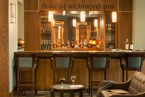 Pub counter and stools with lounge seating in the foreground.