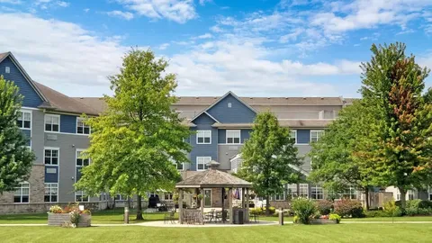 Residence behind lawns, gardens and a gazebo