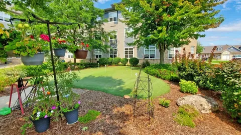 Garden with flowers and a putting green beside the residence