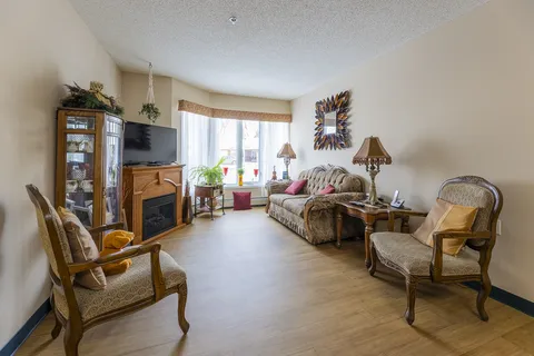 Suite living room with sofa, armchairs and display cabinet.
