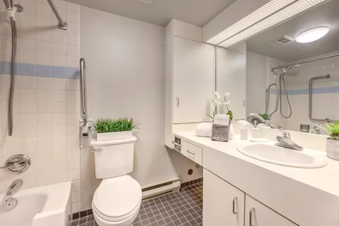 Bathroom with a sink, bathtub, toilet and plants