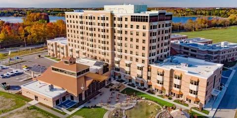 Aerial view of the residence buildings, landscaped grounds and nearby trees