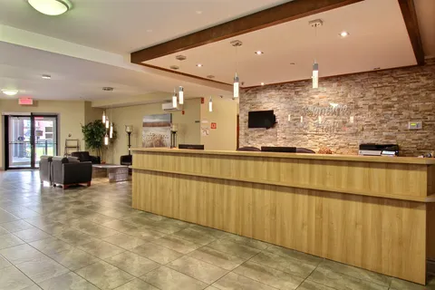 Reception lobby with a wood counter and seating.