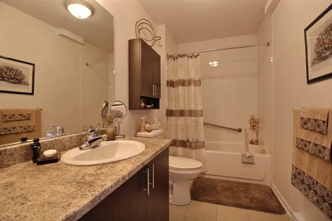 Bathroom with a sink, bath and shower curtain.