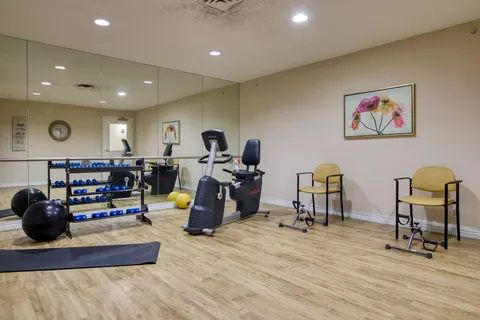 Exercise room with weights, stationary bikes and chairs