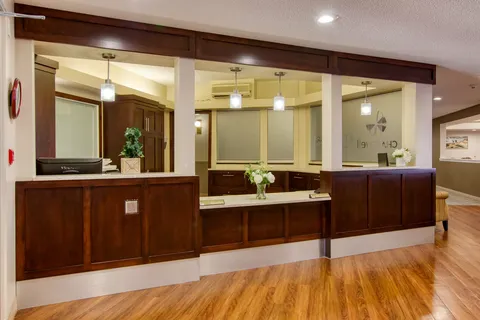 Reception desk with wood panels and a glass partition