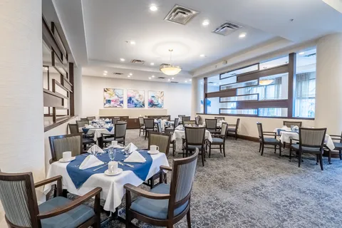 Dining room with set tables and upholstered chairs
