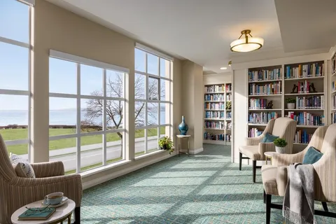 Library seating beside large windows overlooking the waterfront.