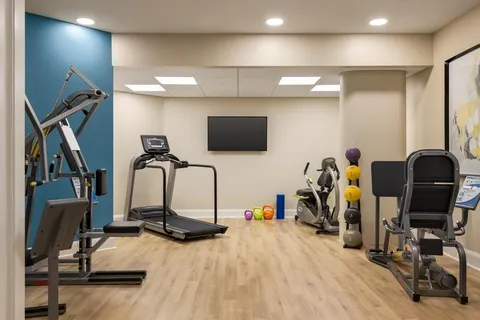 Fitness room with exercise machines and free weights.