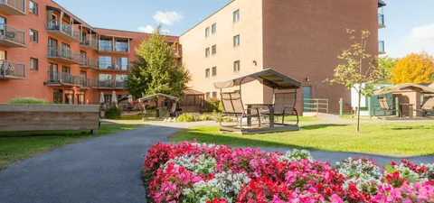 Courtyard with paths, flowers, lawns and sheltered seating