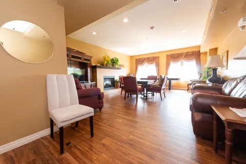 Shared living area with leather seating and dining tables.