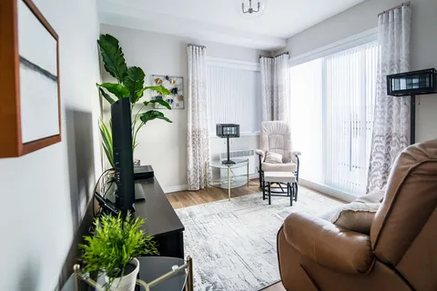 Suite sitting area with armchairs and large windows.