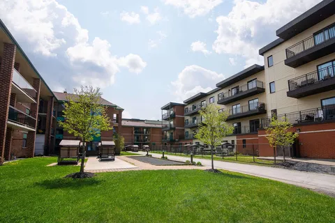 Residence buildings with balconies surrounding a courtyard.