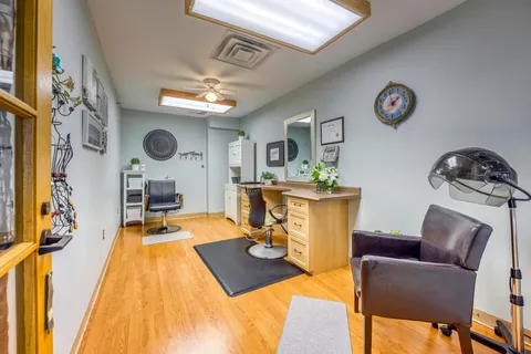 Hair salon with two styling chairs, mirrors and a hair dryer