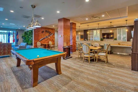 Billiards room with a pool table and counter seating.