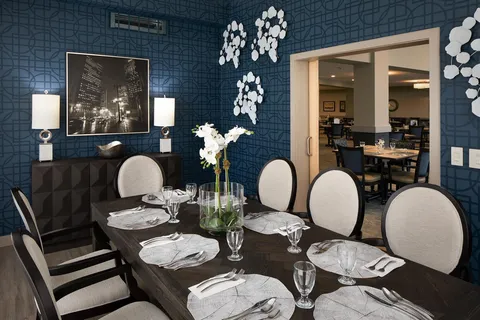 Private dining room with a long table and floral centrepiece.