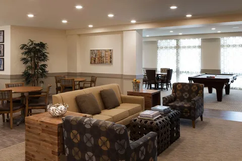 Games room with a pool table and sofas.