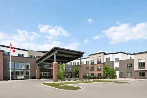Residence building with a covered entrance and landscaped frontage.