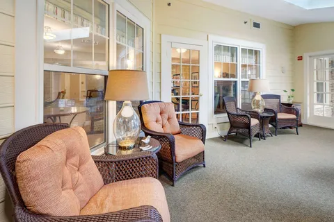 Room with armchairs, glass interior windows and bookshelves