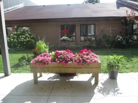 Flower planters beside a lawn and the brick residence