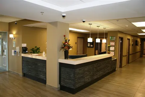 Reception counter with flower arrangement beside a corridor
