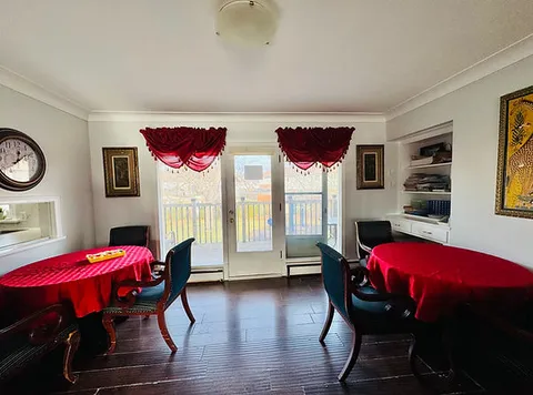 Dining tables beside glass patio doors.