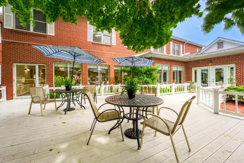 Patio with metal tables, chairs and striped umbrellas