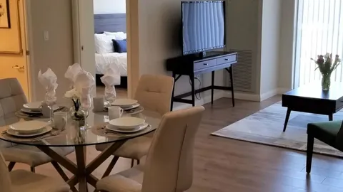 Suite dining and sitting area beside a patio door.