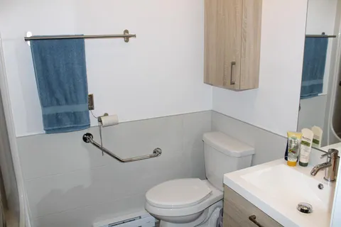 Bathroom with a sink, mirror and toilet