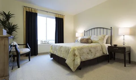 Bedroom with an iron bed frame, bedside tables and lamps