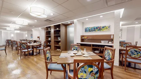 Dining room with set tables and built-in shelving.