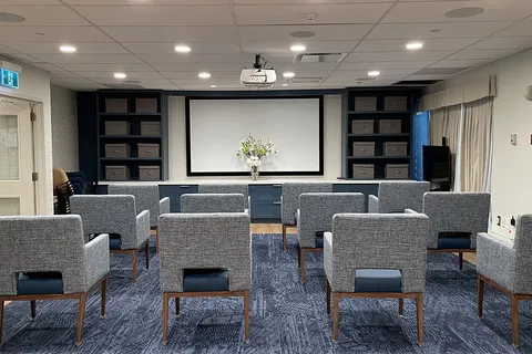 Screening room with rows of chairs and a projection screen.