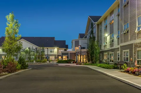 Building and landscaped driveway at dusk