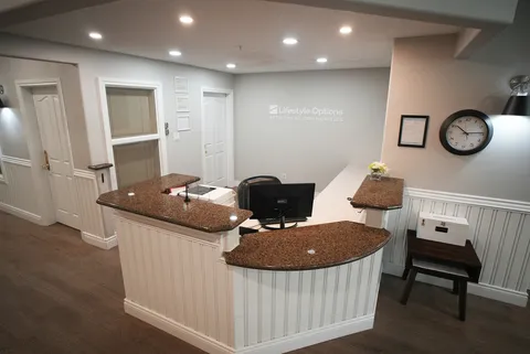 Reception counter with chairs, a clock and doors