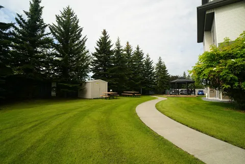 Lawn and a curved path beside the residence