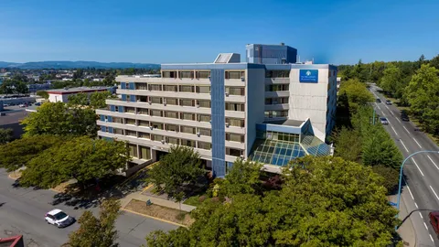 Aerial view of the multi-storey residence beside trees and streets.