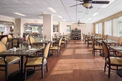 Dining room with set tables, upholstered chairs and ceiling fans