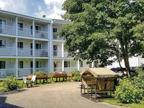 Courtyard with a covered swing, raised flower beds and balconies