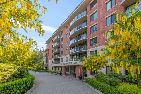 Terrace East exterior beside trees and a paved pathway.