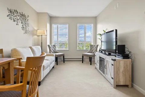 Sitting area with a sofa, two armchairs and a television