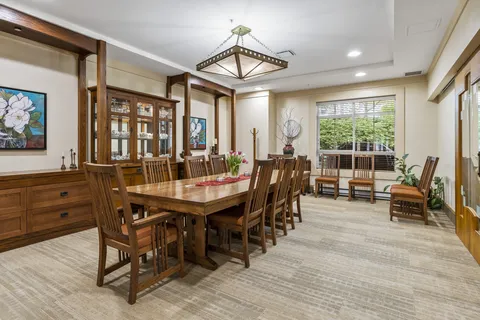 Dining room with a long wooden table, chairs and a china cabinet